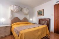 a bedroom with a bed with a yellow blanket at Hotel Casa Boccassini in Venice