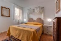 a bedroom with a bed with a yellow bedspread at Hotel Casa Boccassini in Venice