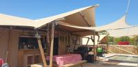 a tent on a deck next to a pool at Larah Land 4 Star Glamping Yala Lodge plus kids lodge in Šimuni