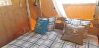 a bed in a room with two pillows on it at Larah Land 4 Star Glamping Yala Lodge plus kids lodge in Šimuni