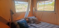 a small bed in a room with a window at Larah Land 4 Star Glamping Yala Lodge plus kids lodge in Šimuni