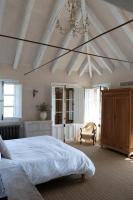 a bedroom with a large bed and a white ceiling at Casa La Siesta in Vejer de la Frontera