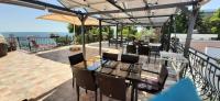 a patio with a table with chairs and an umbrella at Vila pe plaja nr 9 in Saturn