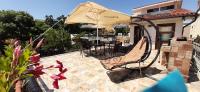 a patio with an umbrella and a table and chairs at Vila pe plaja nr 9 in Saturn