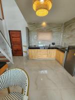 a kitchen with a refrigerator and a counter top at Haadson Resort & Koh Raham in Haad Son