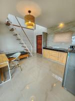 a living room with a staircase and a table at Haadson Resort & Koh Raham in Haad Son