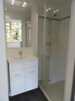 a bathroom with a sink and a shower at Pavillon Kalensa in Vals-les-Bains