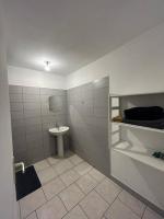 a bathroom with a sink and a toilet at Appartement Le Tangor in Saint-Leu