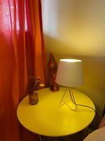a table with a lamp and a plant on it at SousmonToi in Illkirch-Graffenstaden