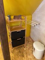 a small bathroom with a shelf and a toilet at SousmonToi in Illkirch-Graffenstaden