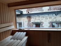 a bench sitting in front of a window at Loft en duplex 270 m2 &amp; Jardin patio terrasse sauna in Chaville