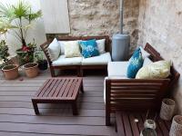 a patio with a couch and a table and a bench at Loft en duplex 270 m2 &amp; Jardin patio terrasse sauna in Chaville