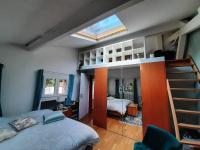 a bedroom with a bed and a bunk bed at Loft en duplex 270 m2 &amp; Jardin patio terrasse sauna in Chaville