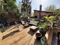 a rooftop patio with furniture and potted plants at Loft en duplex 270 m2 &amp; Jardin patio terrasse sauna in Chaville