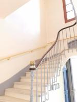 a staircase in a home with a white stair case at LE MEDITERRANEEN *T2 (40m²) *WIFI*PARKING PRIVE* in Lourdes