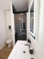 a white bathroom with a sink and a toilet at LE MEDITERRANEEN *T2 (40m²) *WIFI*PARKING PRIVE* in Lourdes