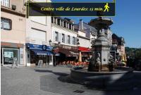 a fountain in the middle of a city street at LE MEDITERRANEEN *T2 (40m²) *WIFI*PARKING PRIVE* in Lourdes