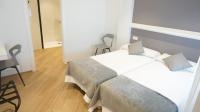 A bed or beds in a room at Hostal León