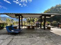 a pavilion with a picnic table and a blue chair at Zhong Ming Ju Taoyi Fang in Fanlu