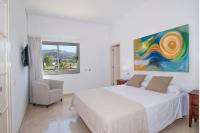 A bed or beds in a room at Tauro Villas Deluxe