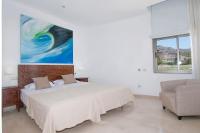 A bed or beds in a room at Tauro Villas Deluxe