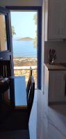 a kitchen with a table and a view of the ocean at Diakofti house by the sea - Kythoikies hoilday houses in Kythira