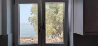 a window with a view of the ocean through it at Diakofti house by the sea - Kythoikies hoilday houses in Kythira