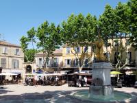 a fountain in the middle of a town square with buildings at Apartment La Caterina-1 by Interhome in Saint-Cyr-sur-Mer