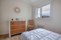 a bedroom with a bed and a dresser and a window at Detente au calme et pres de la plage in Saint-Gildas-de-Rhuys