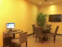 a room with a table with a laptop and chairs at Garden Hotel in Taichung