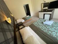 A bed or beds in a room at CASTLE PARK HOTEL