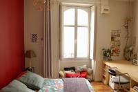 a bedroom with a window and a bed and a desk at Un jardin en ville in Nantes