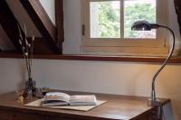 a desk with a book and a lamp on it at Suite Toussaint - Calme &amp; Authentique in Angers