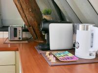 a kitchen counter with a coffee maker and a toaster at Suite Toussaint - Calme &amp; Authentique in Angers