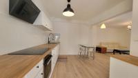 a kitchen with a counter top and a living room at New two bedroom apartment with AC by the sea in Nice