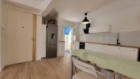a white kitchen with a counter and a refrigerator at New two bedroom apartment with AC by the sea in Nice