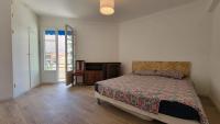 a bedroom with a bed and a door to a balcony at New two bedroom apartment with AC by the sea in Nice