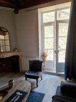 a living room with a chair and a window at La Maison du Bonheur - Logement entier de 39 m2 in Bourg-en-Bresse