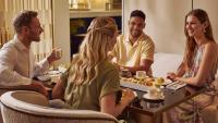 a group of people sitting around a table eating food at Jumeirah Mina Al Salam Dubai in Dubai