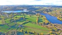 an aerial view of a field and a lake at A l&#39;Orée du Lac, 500m lac de Chamboux in Saint-Martin-de-la-Mer