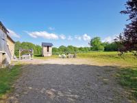 a dirt field with a playground and a building at A l&#39;Orée du Lac, 500m lac de Chamboux in Saint-Martin-de-la-Mer