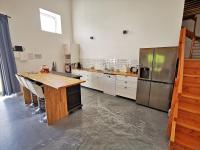 a large kitchen with a wooden counter and a refrigerator at A l&#39;Orée du Lac, 500m lac de Chamboux in Saint-Martin-de-la-Mer