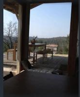 a view from the porch of a house with a table at Les Faveyrolles à Labeaume in Labeaume