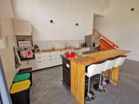 a kitchen with a wooden counter top in a room at A l&#39;Orée du Lac, 500m lac de Chamboux in Saint-Martin-de-la-Mer