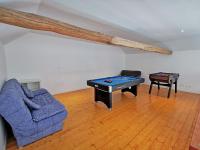 a living room with a pool table and a couch at A l&#39;Orée du Lac, 500m lac de Chamboux in Saint-Martin-de-la-Mer