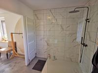 a bathroom with a shower with a glass door at A l&#39;Orée du Lac, 500m lac de Chamboux in Saint-Martin-de-la-Mer