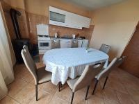a kitchen with a table with chairs and a kitchen with white cabinets at Mara in Zadar