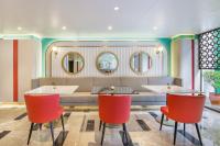 a restaurant with two tables and red chairs at Dusit Princess Kathmandu in Kathmandu