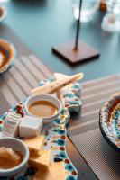 a plate of cheese and two cups of coffee on a table at Splendid Hotel Taormina in Taormina