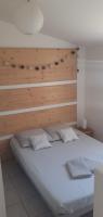 a bedroom with a large bed with a wooden headboard at Mas Vincent in La Fare-les-Oliviers